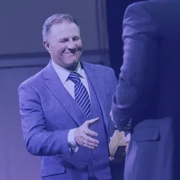 Dean Hartley shaking hands with a client