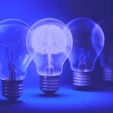 A row of light bulbs, one glowing with a brain inside